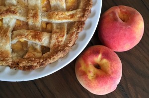 Peach Pie alongside fresh peaches
